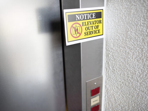 Elevator door with a posted out-of-service notice.